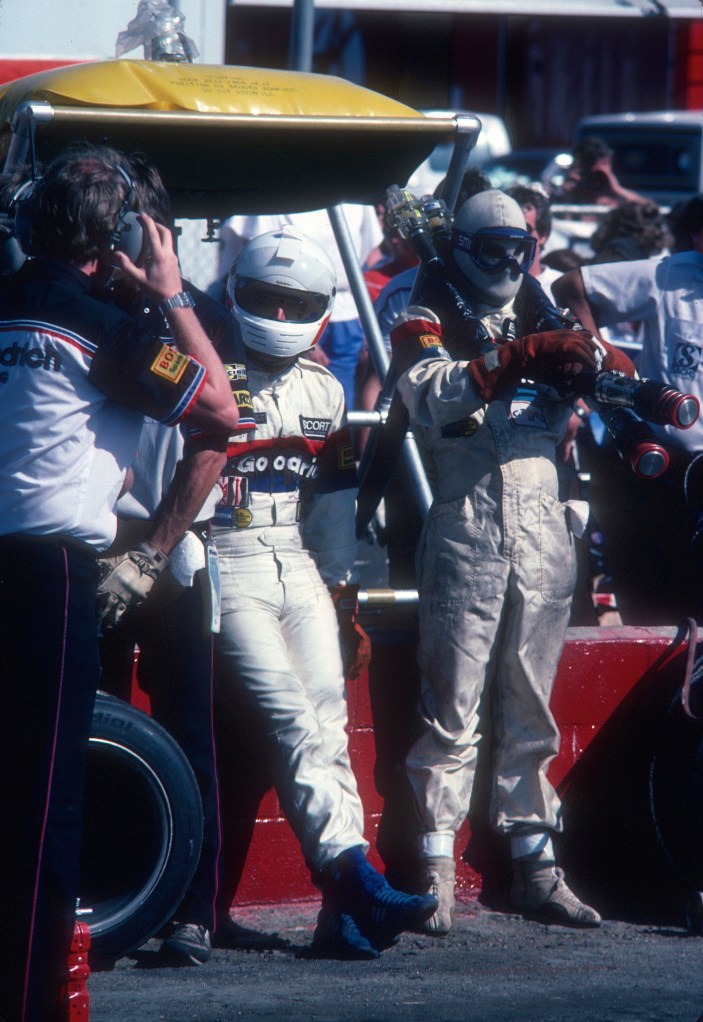 Rick Knoop waiting to make driver change with Jim Busby_#67 BFGoodrich Porsche 962_Riverside Raceway_April 1985 Rick Knoop waiting to make driver change with Jim Busby_#67 BFGoodrich Porsche 962_Riverside Raceway_April 1985