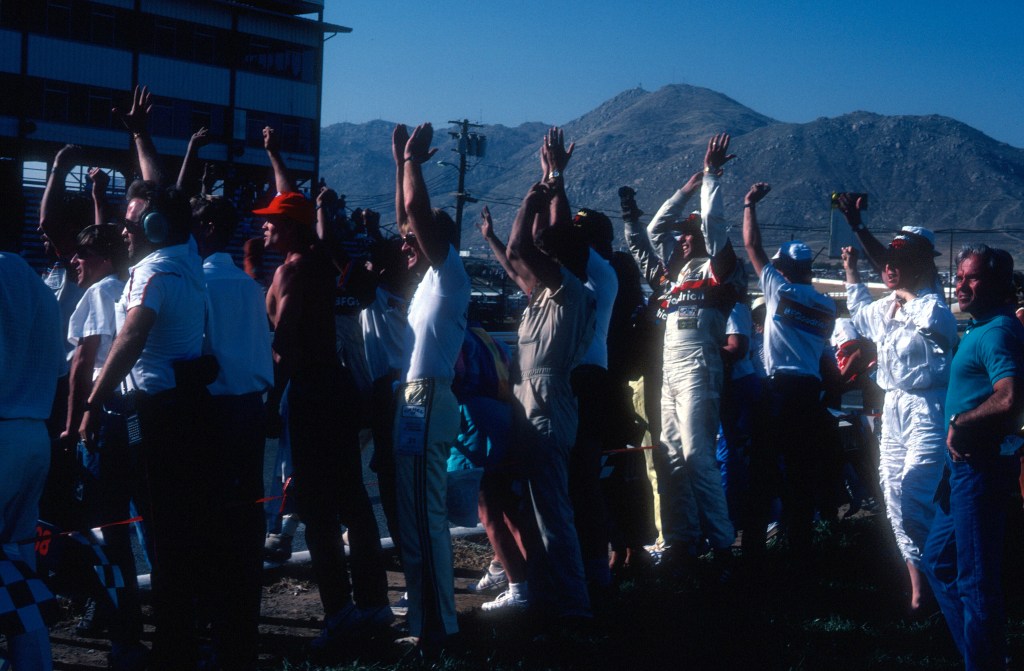 Jim Busby and team cheering on#68 BFGoodrich Porsche 962_start/finish_Riverside Raceway_April 1985 Jim Busby and team cheering on#68 BFGoodrich Porsche 962_start/finish_Riverside Raceway_April 1985