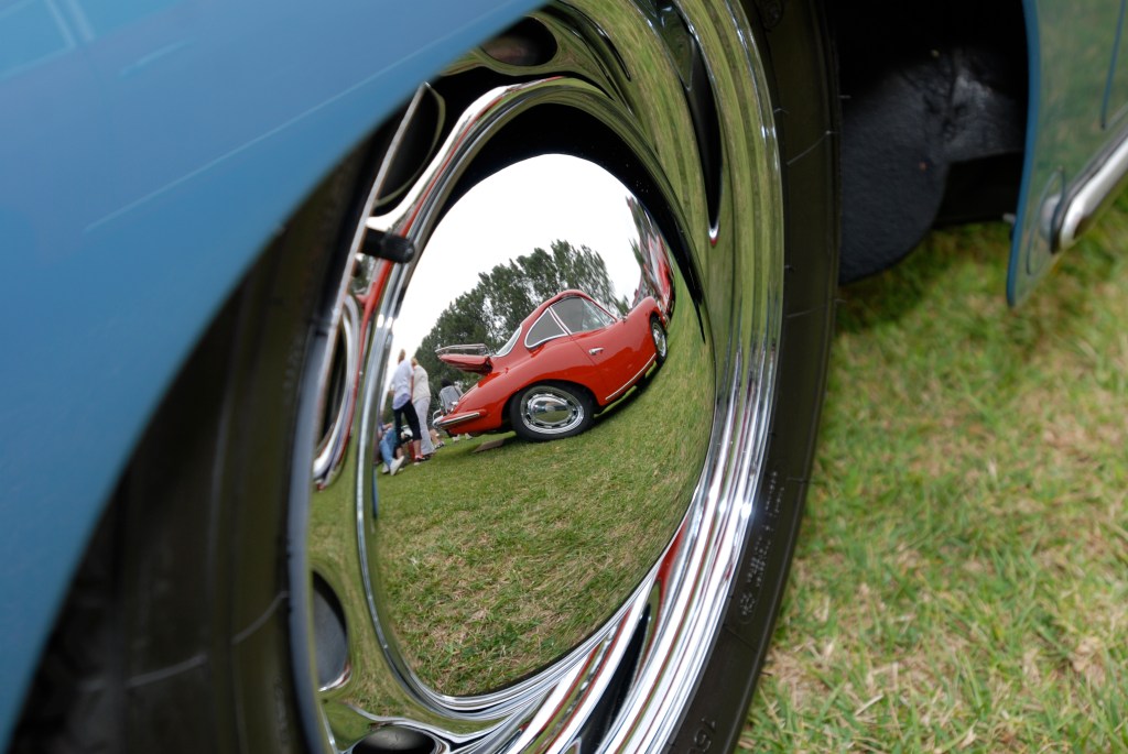 Porsche 356 Registry_ reflection in speedster hubcap/red 356 coupe_Dana Point concours _July 15, 2012