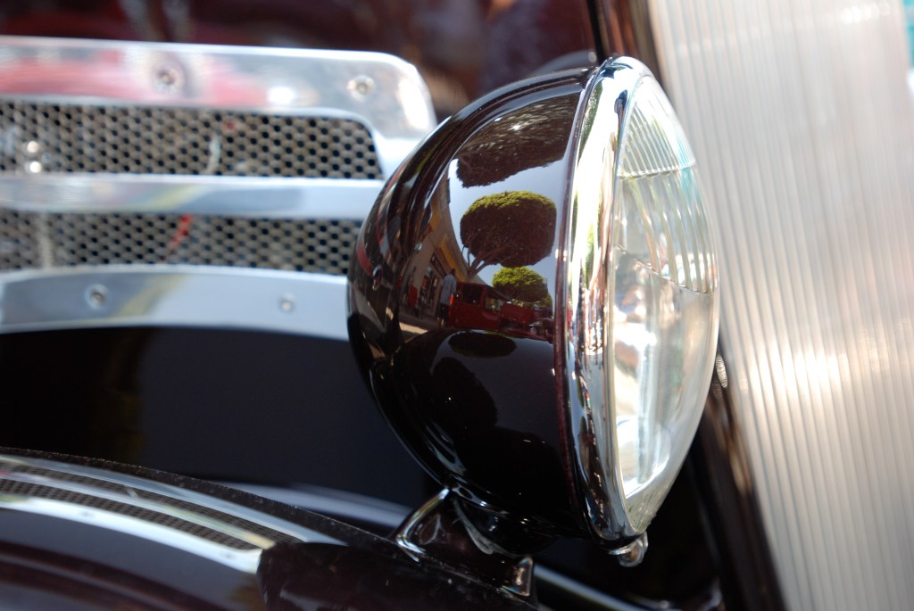 Root beer brown 1934 Ford 3 window coupe_headlight housing with reflections_ 12th Annual Uptown Whittier Car Show_August 18, 2012 Root beer brown 1934 Ford 3 window coupe_headlight housing with reflections_ 12th Annual Uptown Whittier Car Show_August 18, 2012