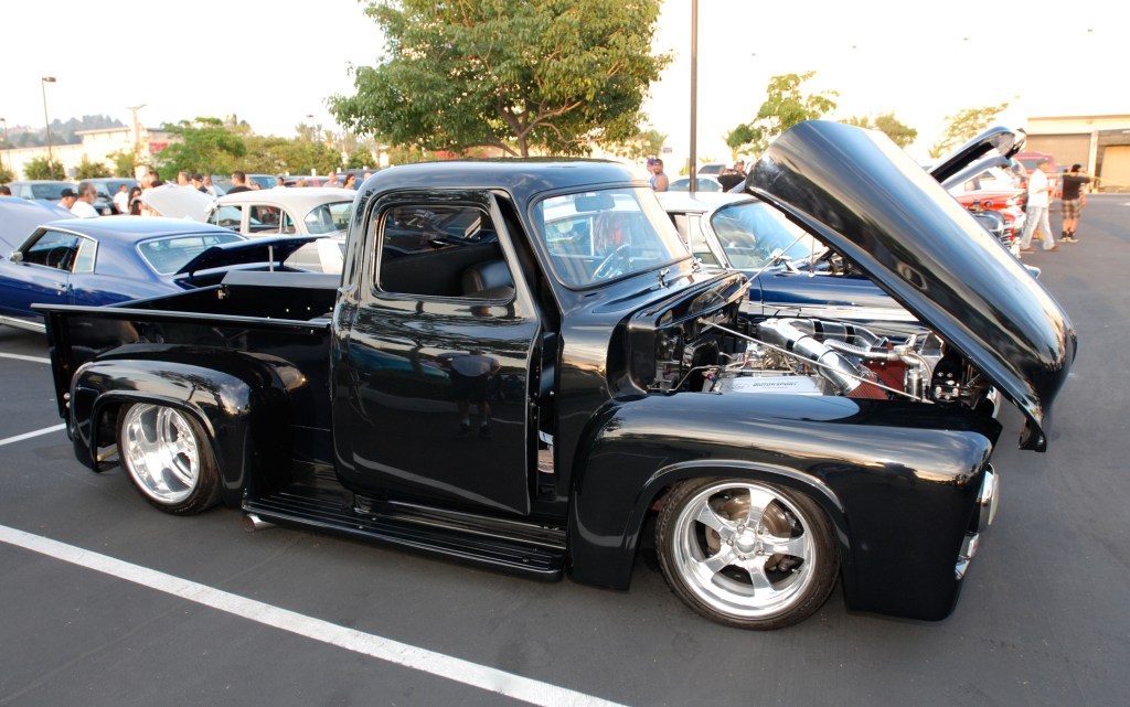 Black  1950's vintage Ford F-100 custom truck_3/4 side view and reflections_Ruby's Diner car show_ Whittier,California_August 3, 2012