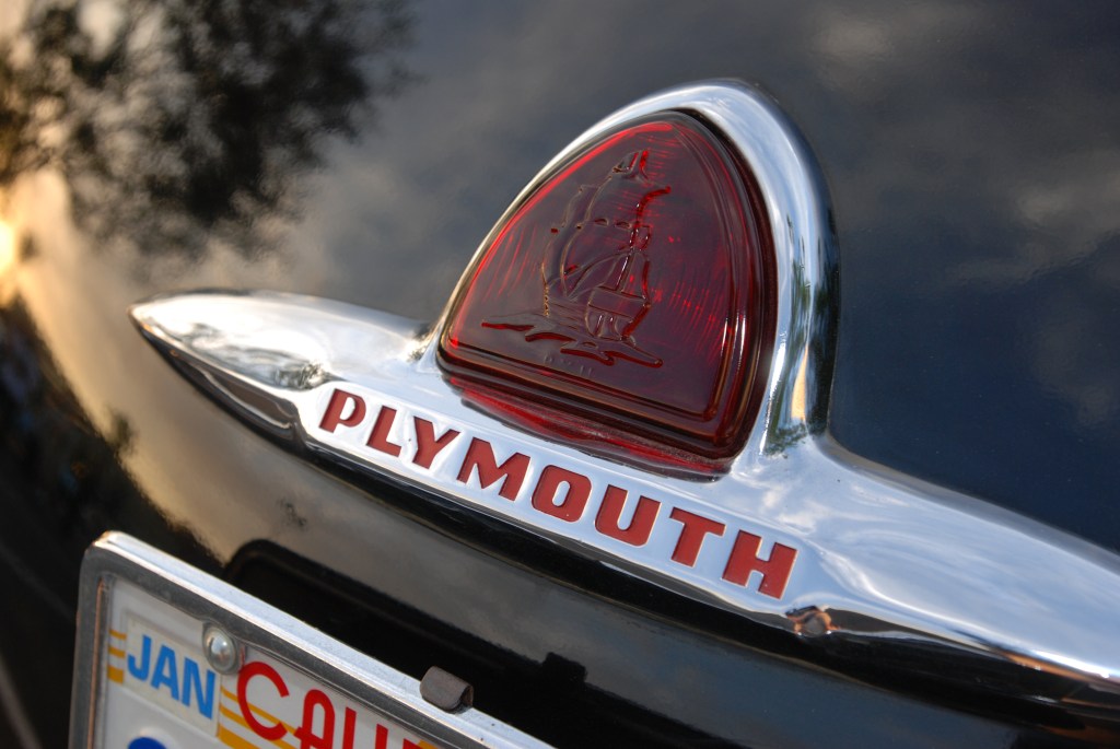 Black Plymouth Sedan_rear trunk badge_Ruby's Diner car show_ Whittier,California_August 3, 2012 Black Plymouth Sedan_rear trunk badge_Ruby's Diner car show_ Whittier,California_August 3, 2012