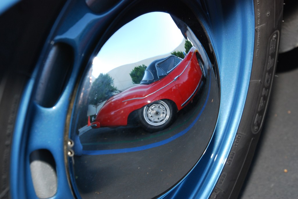 Red 1957 356A Porsche speedster reflection in blue 356A coupe hubcap_Cars&Coffee_October 27, 2012