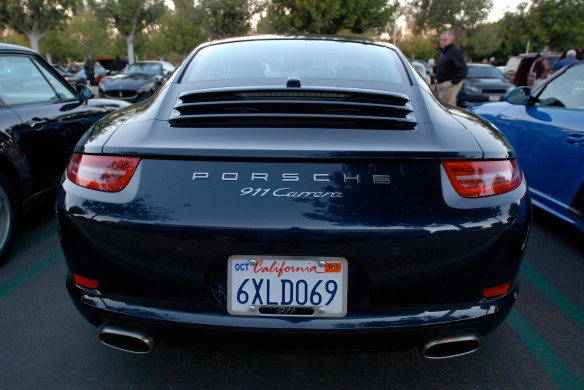 Dark Blue metallic 2013 Porsche type 991, 911 Carrera_ rear view; badging with sunrise reflections_Cars&Coffee/Irvine_January 12, 2013