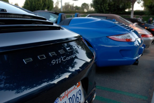 Dark Blue metallic 2013 Porsche type 991, 911 Carrera_ partial rear view with sunrise reflections and 997 Speedster in background_Cars&Coffee/Irvine_January 12, 2013