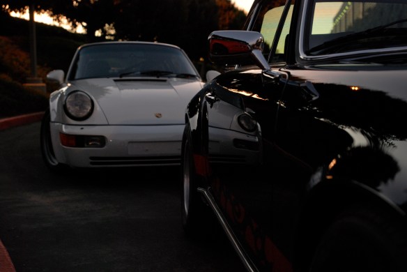 Black 1973 Porsche 911 Carrera RS & white1991 Porsche 964 turbo_ side reflections in Carrera RS w/sunrise lighting_Cars&Coffee/Irvine_January 19, 2013