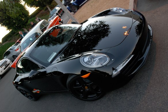Black 2013 Porsche type 991 / 911 Carrera_angled 3/4 front view with sunrise reflections_Cars&Coffee/Irvine_January 19, 2013