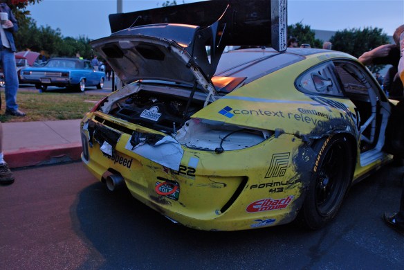 Truspeed yellow & black # 80, Porsche GT3 Cup car_3/4 rear view w/missing taillight and heavy collision damage_Cars&Coffee/Irvine_February 2, 2013