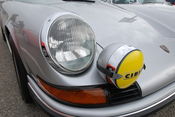 Silver 1972 Porsche 911S  from trio of one family's three Porsche 911s _Porsche Corral_fender reflections, headlight and foglight details_California Festival of Speed_April 6, 2013