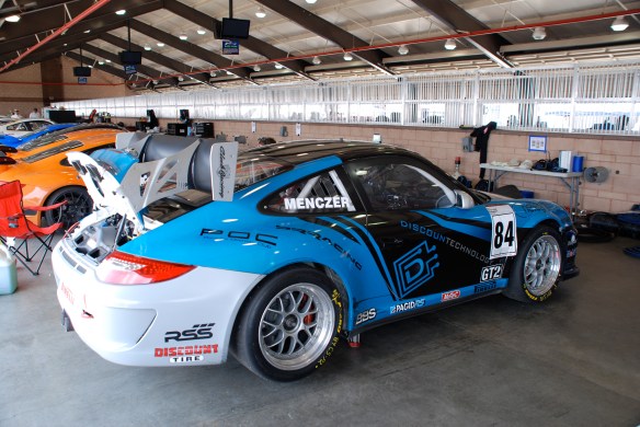 Blue, Black and white, DiscounTechnology Porsche GT3 Cup car_ Garage 3_3/4 rear view_California Festival of Speed_April 6, 2013