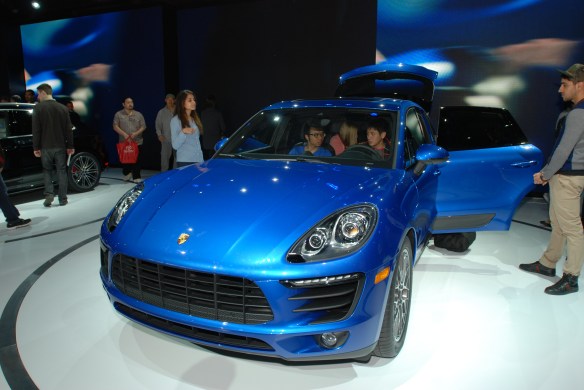 Blue 2014 Porsche Macan_front view with open doors and reflections_LA Auto Show_ November 23, 2013 Blue 2014 Porsche Macan_front view with open doors and reflections_LA Auto Show_ November 23, 2013