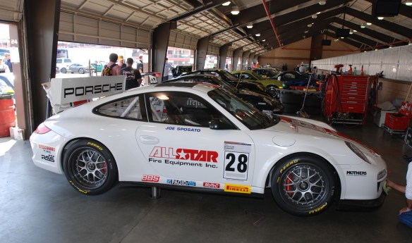 white w/red and blue stripe, All Star # 28  Porsche  type 997 GT3 Cup car_ side view in garage _California Festival of Speed_4/5/14