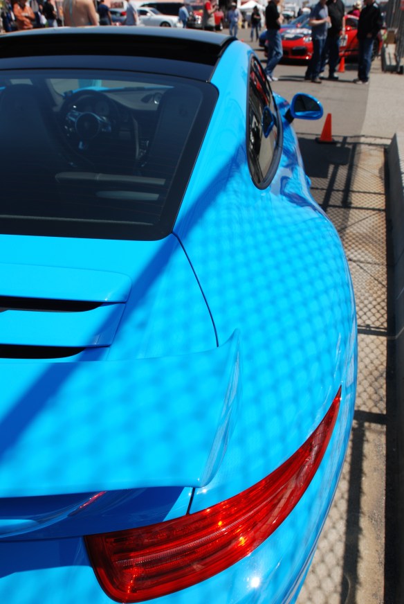 2013 Riviera Blue Porsche 991 w/ aerokit_3/4 rear view with fence shadows on pit row_California Festival of Speed_4/5/14